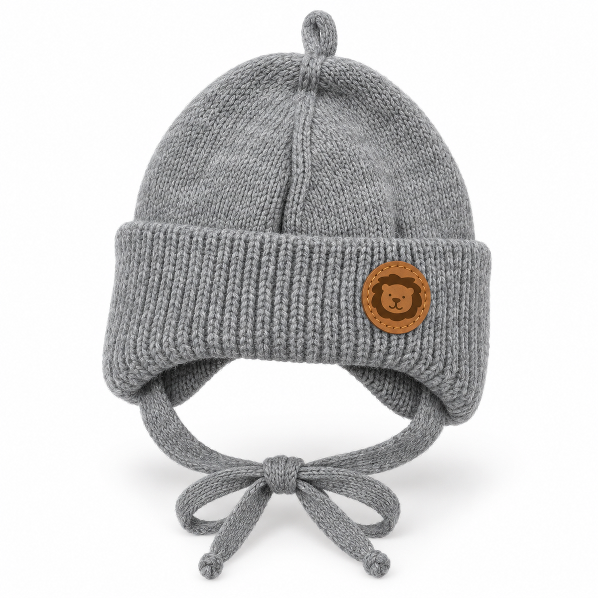 Grey knitted baby cap with lion patch, chunky ribbed cuff, ear flaps and tie strings – front view