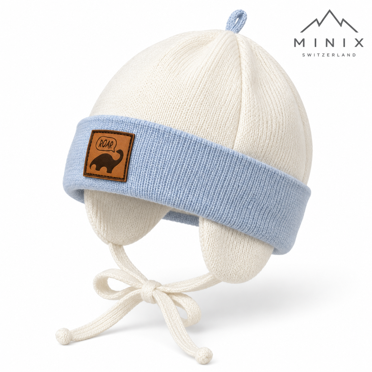 Cream and light blue knitted baby cap with dino patch and ear flaps – angled view