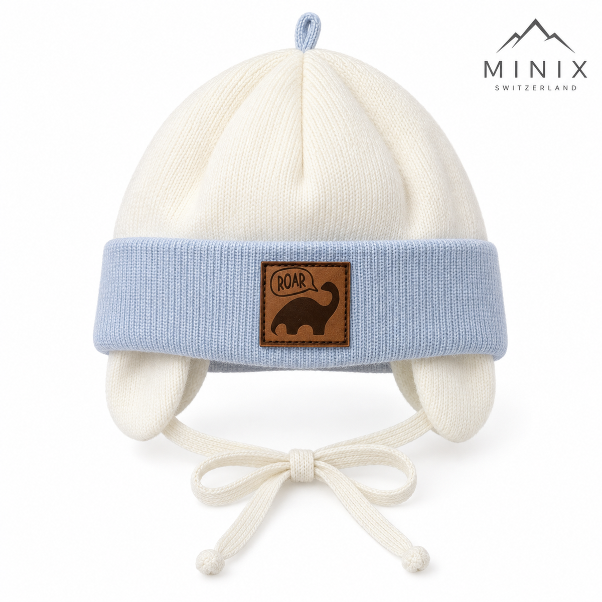 Cream knitted baby cap with light blue cuff, dino patch and loop on top – front view
