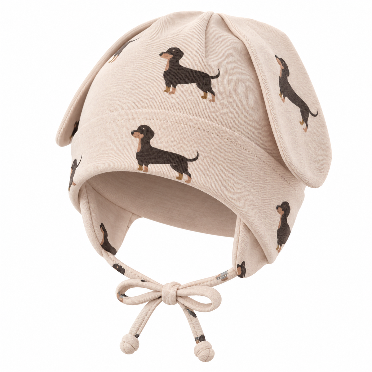 Beige baby puppy ear cap with dachshund pattern – angled product shot by MINIX Switzerland