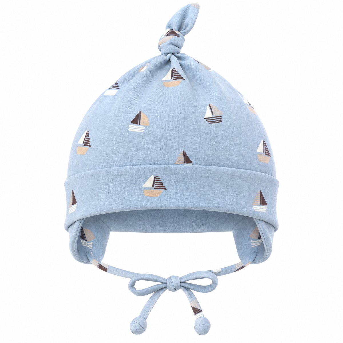 Boy wearing light blue sailboat print cotton cap with knot and ear covers on a sailboat