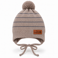 Beige striped knit baby boy cap with pompom, Bon Voyage patch, ear flaps and tie strings – front view