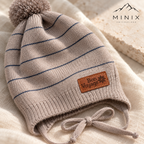 Close-up of the Bon Voyage ship's wheel patch and navy stripes on the beige knitted cap