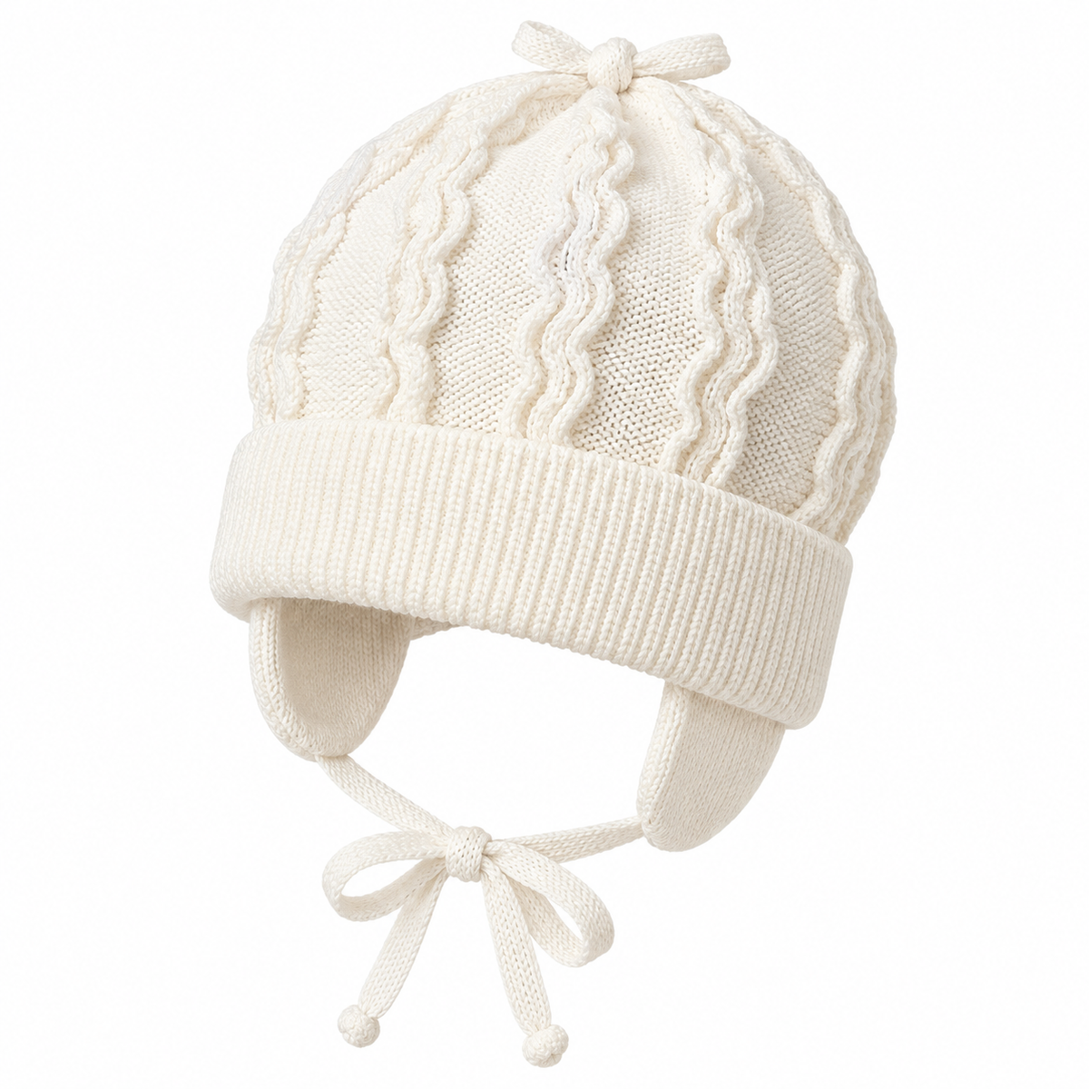 Cream knitted baby cap with wave pattern, knitted bow on top and tie strings – angled view