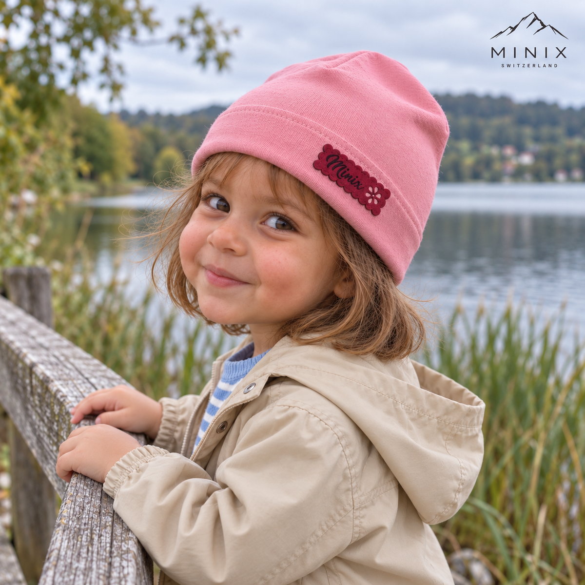 Child wearing the pink MINIX cotton beanie with hot pink label