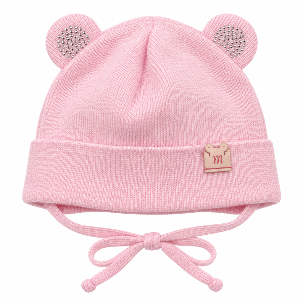 Pink knitted baby girl cap with sparkly round ears, little m patch on the cuff and tie strings – front view