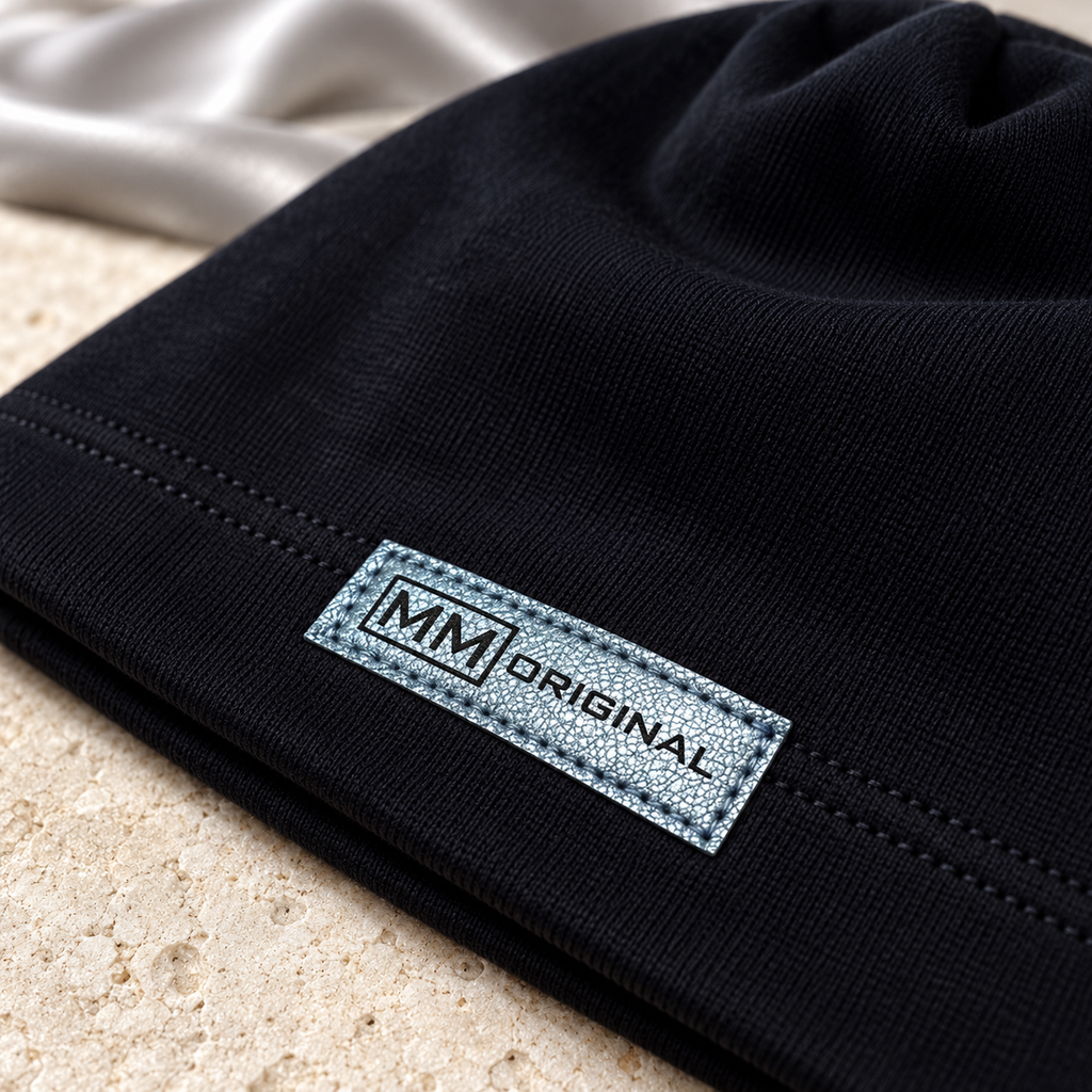 Close-up of the metallic MM Original label on a black kids cotton beanie